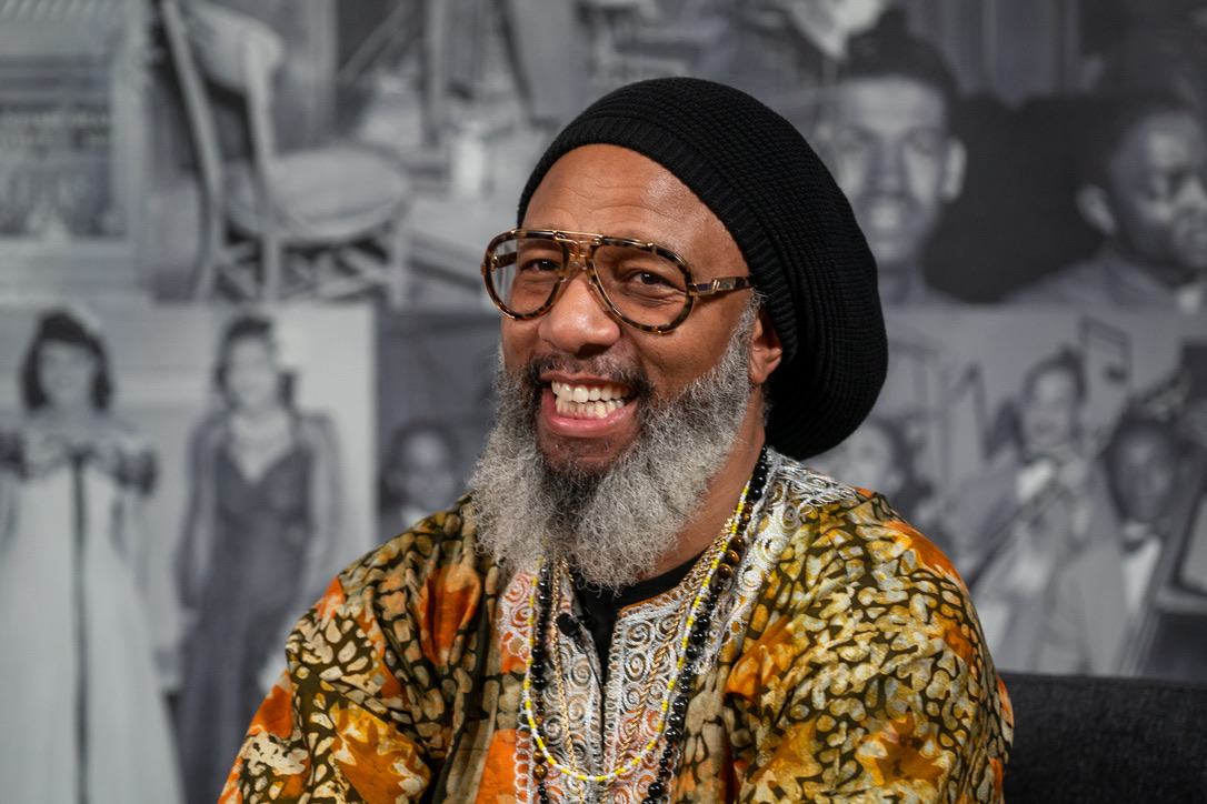 Heru TchaasAmen smiling warmly on The Day with Trae Show