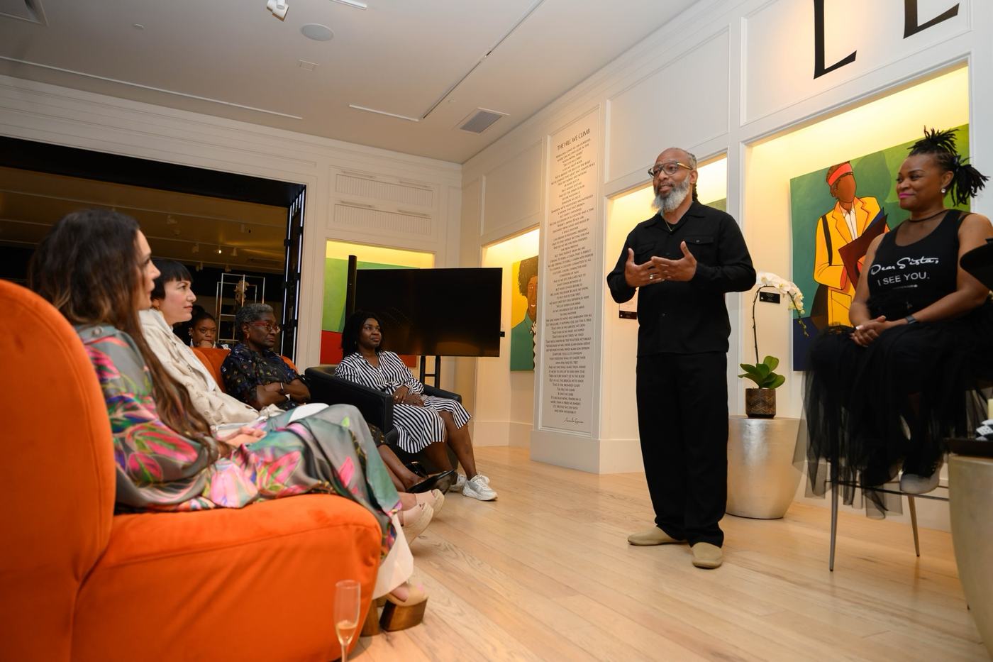Heru TchaasAmen speaking to the full audience at WOW Gallery